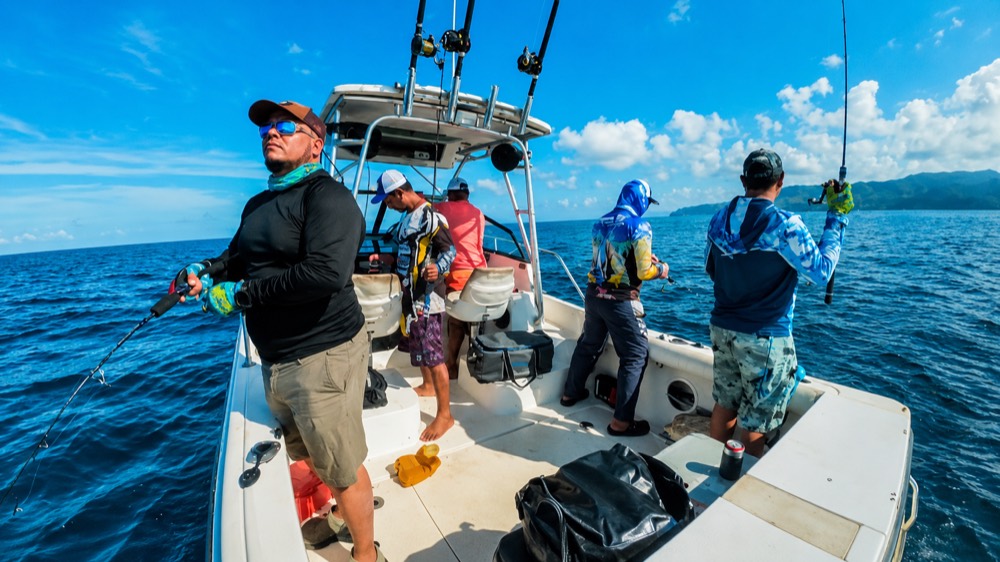 Anglers working the rods on a sportfishing boat off the Pacific coast