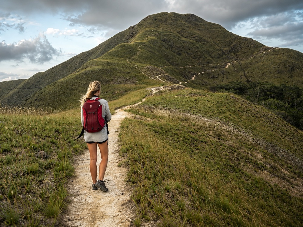 A hiker on a ridge trail in the highlands near Playa Blanca