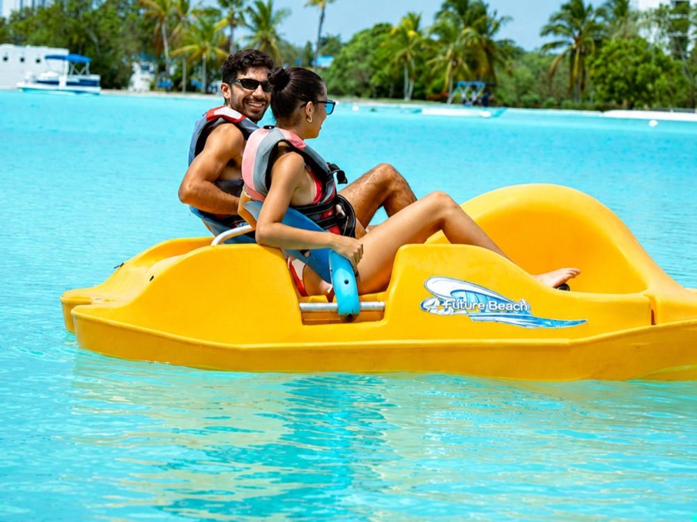 A couple pedal-boating on the crystal lagoon
